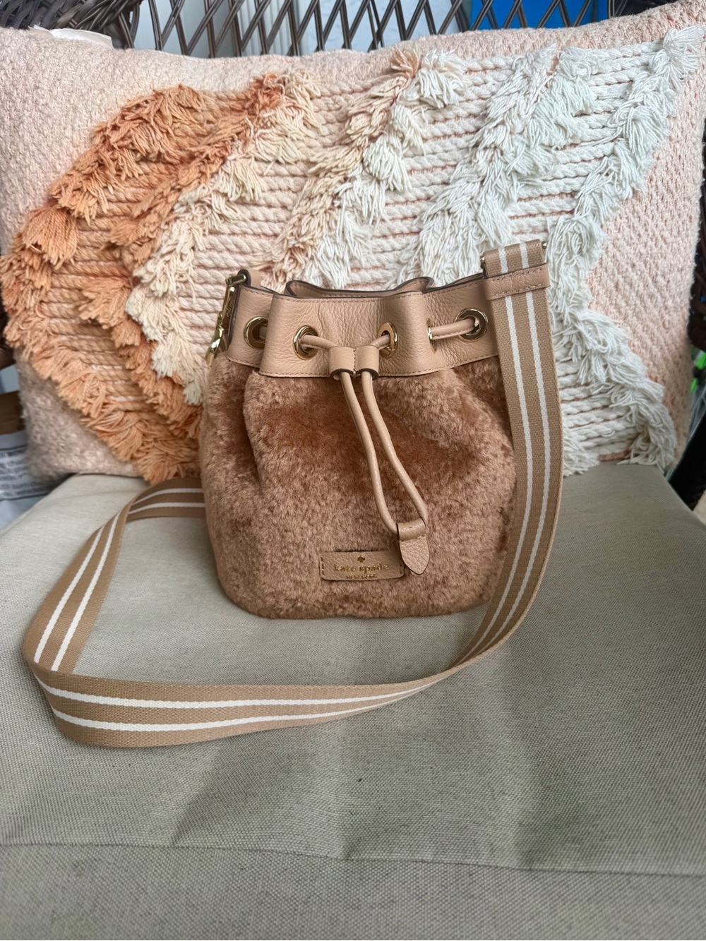 kate spade Tan Shearling Drawstring Bucket Crossbody Bag with Striped Strap